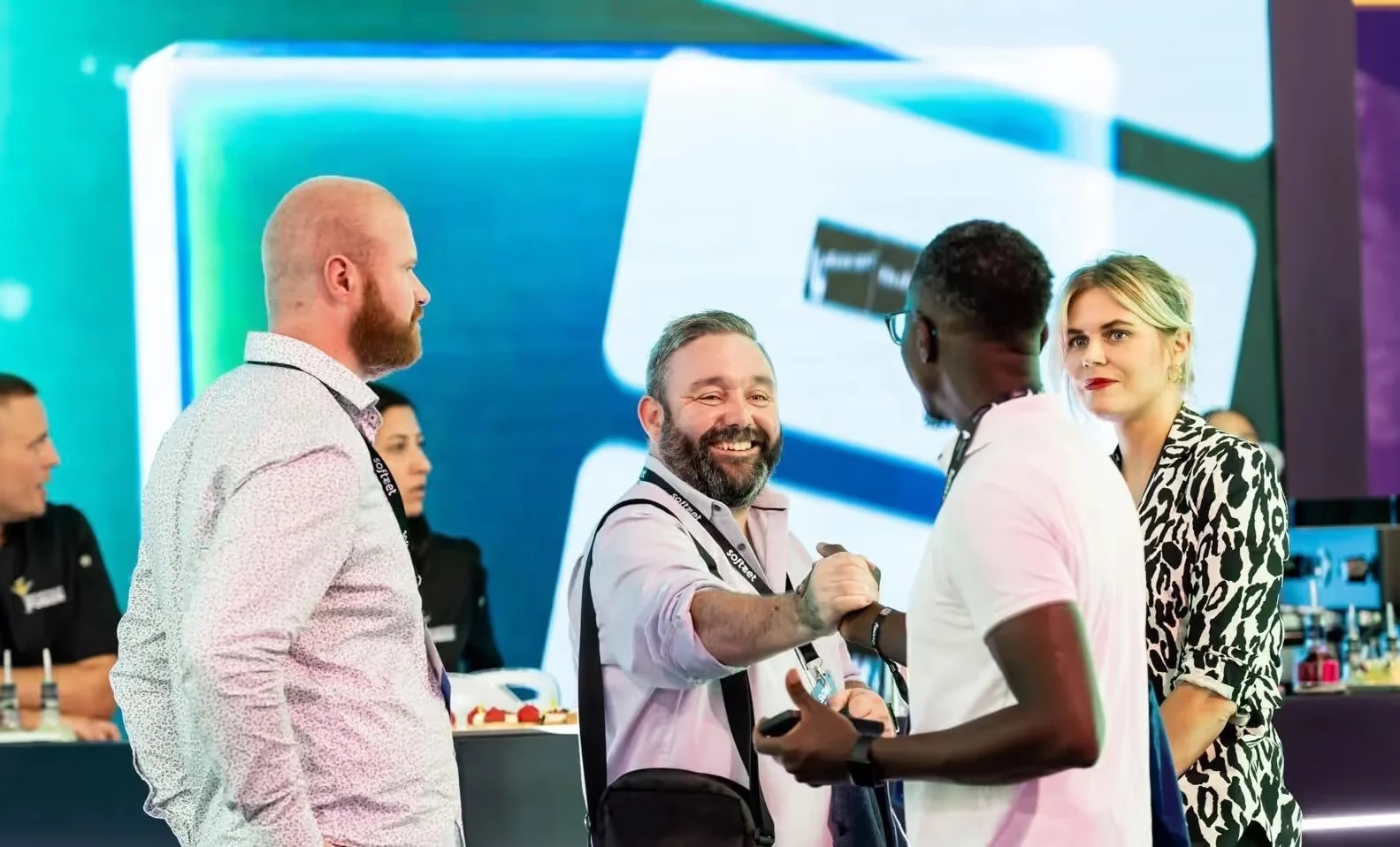 Des représentants de Soft2Bet en discussion avec des fondateurs sur un stand professionnel