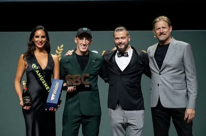 Uri Poliavich and colleagues on stage holding an SBC Awards trophy